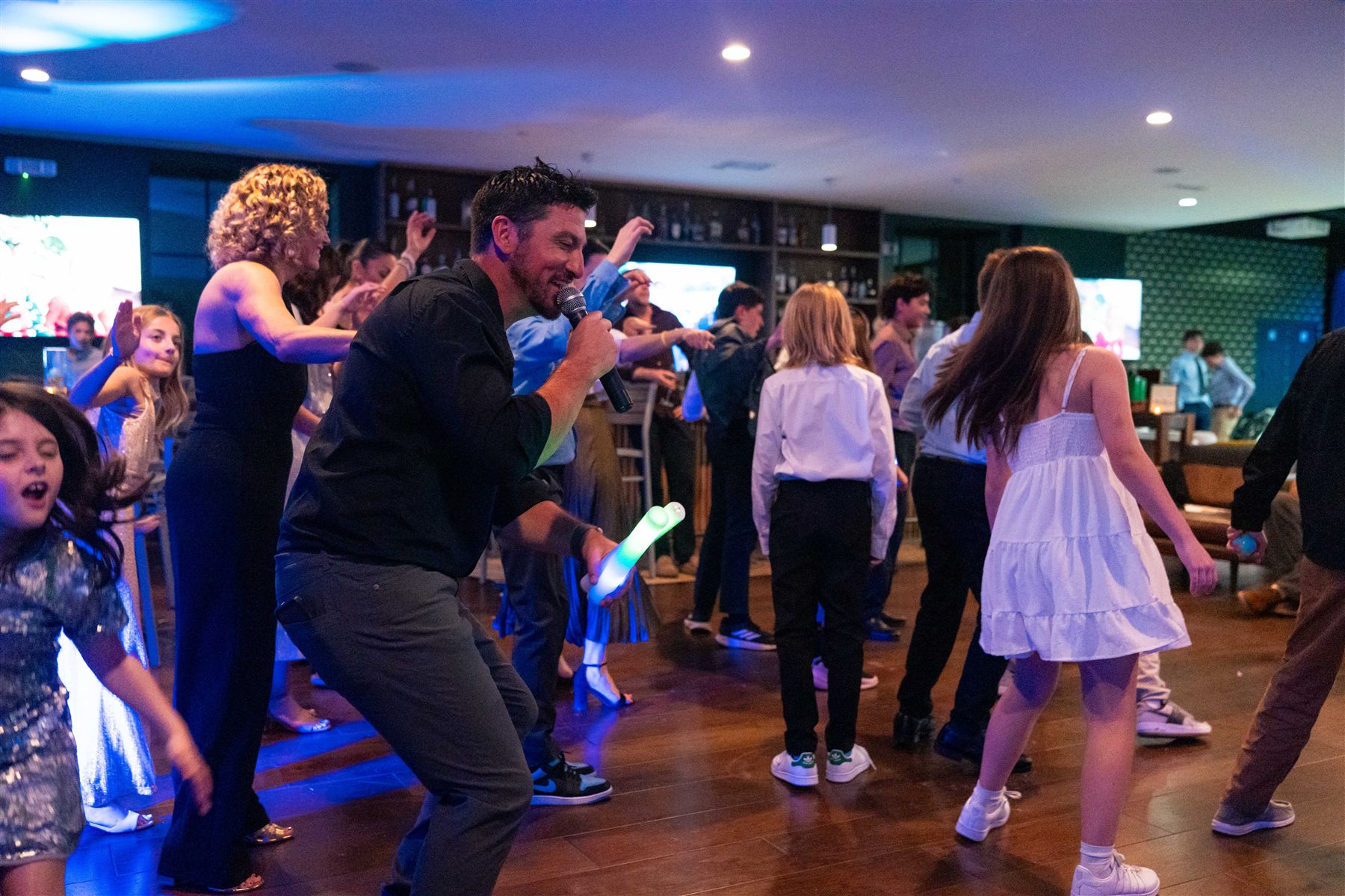 A DJ dancing among guests at a party