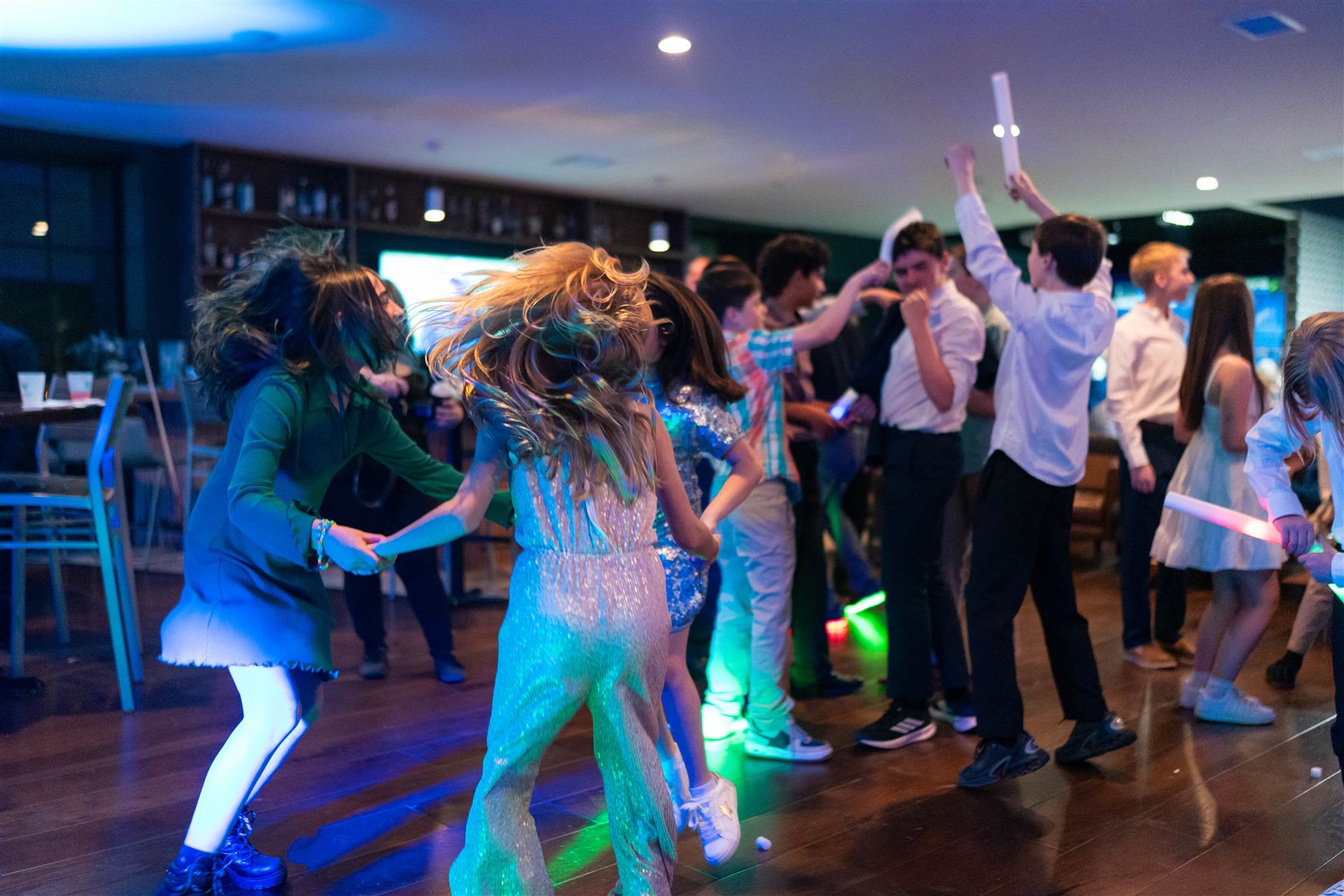 Kids dancing with glow sticks at a Bar Mitzvah