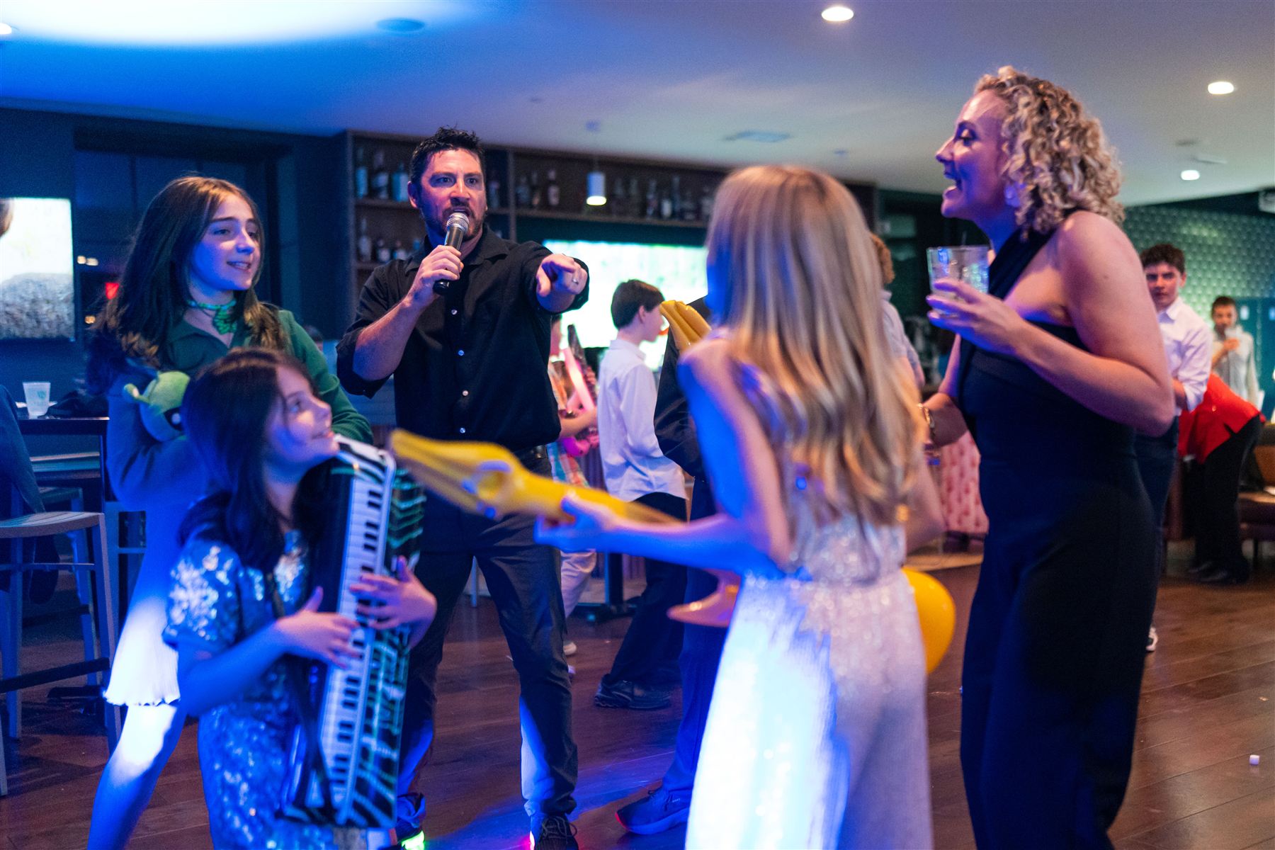 Kids playing inflatable guitars on the dance floor at a Bar Mitzvah